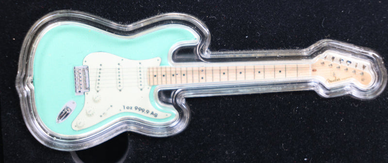 Turquoise electric guitar-shaped object on a black background