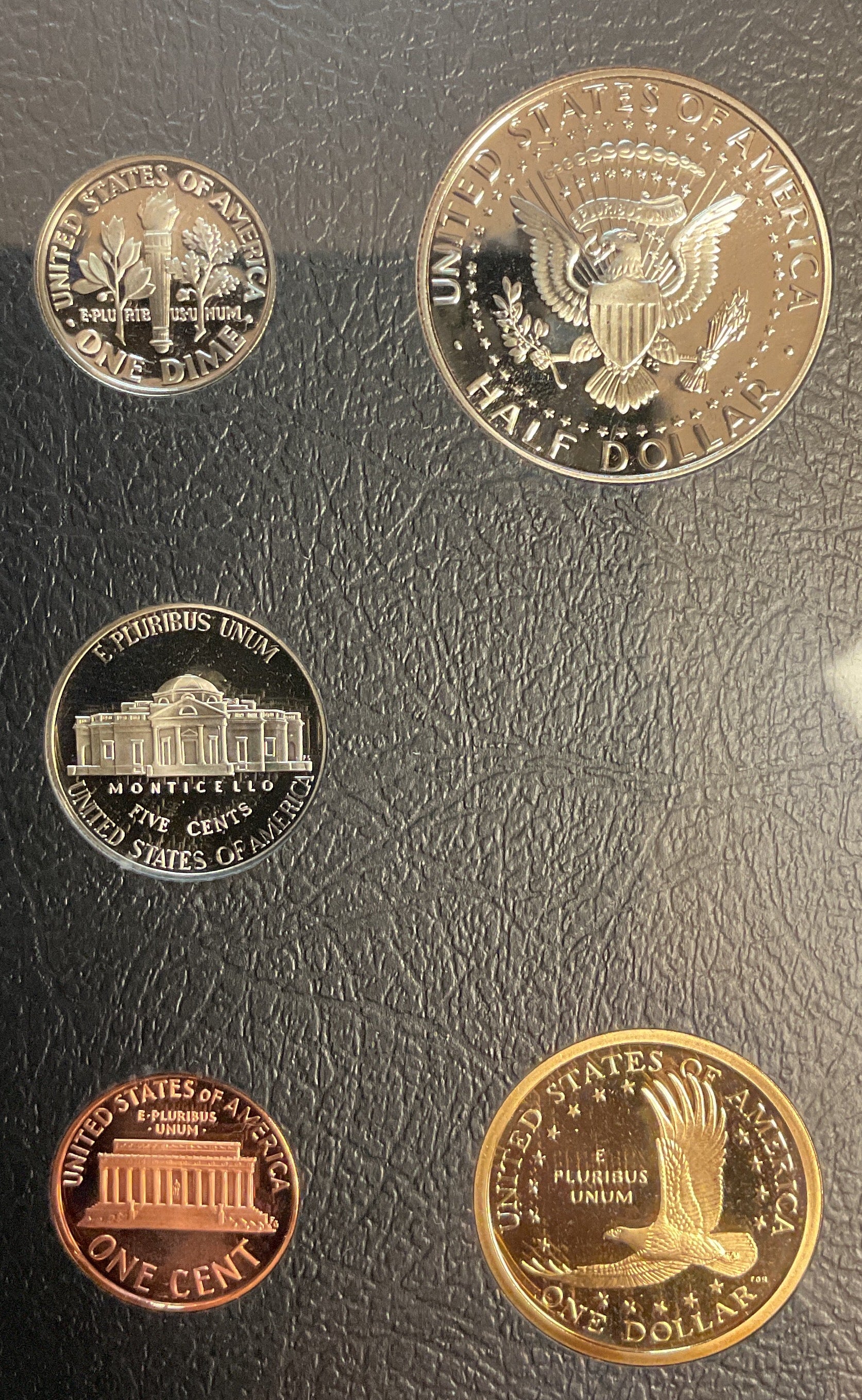 Set of U.S. coins including a penny, nickel, dime, quarter, and half dollar.